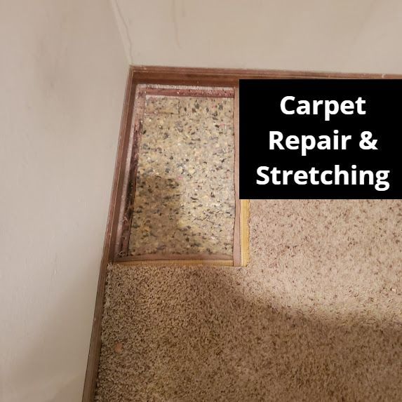 Carpet repair and stretching with visible padding in a doorway.