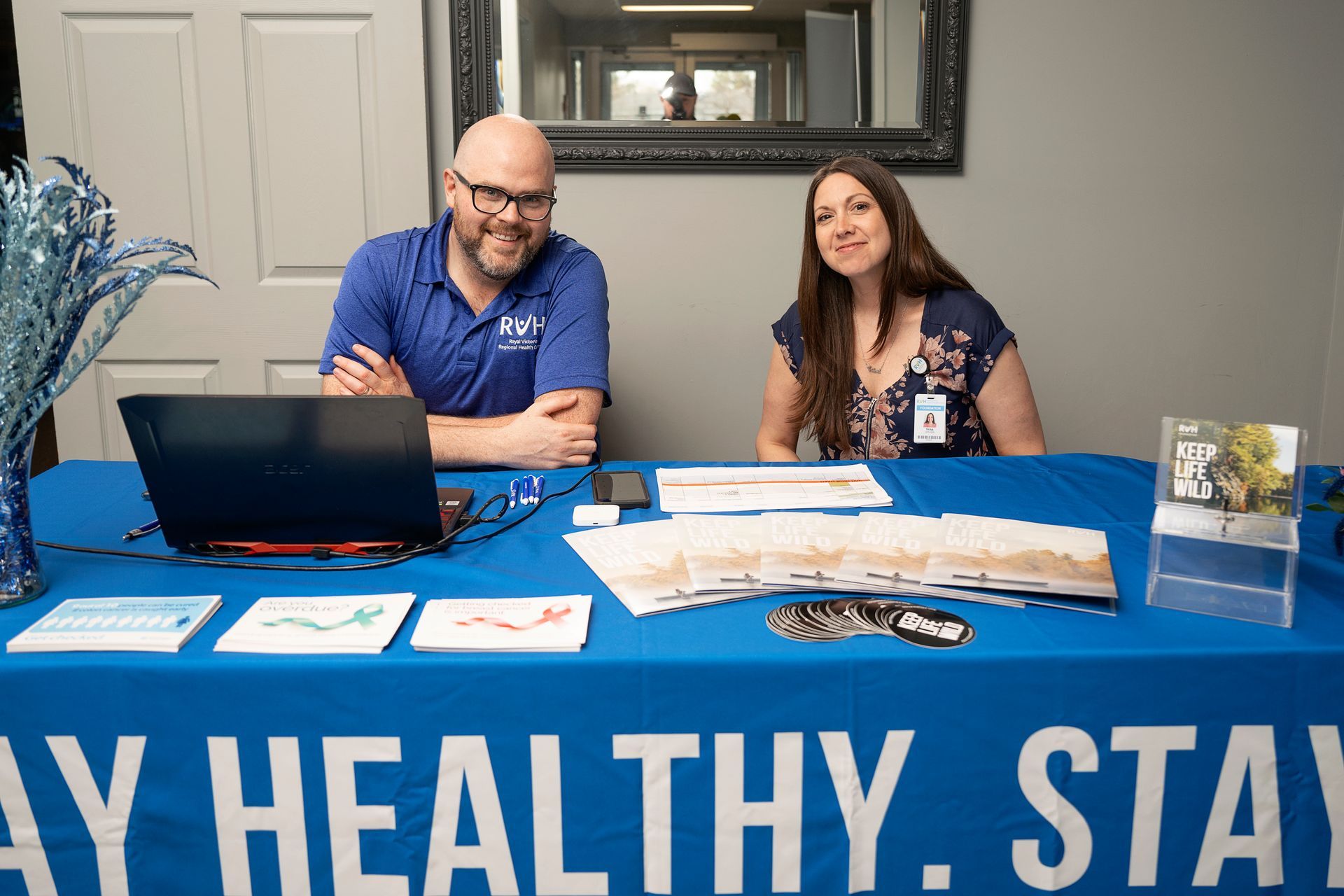 Man and woman smiling behind a table with 