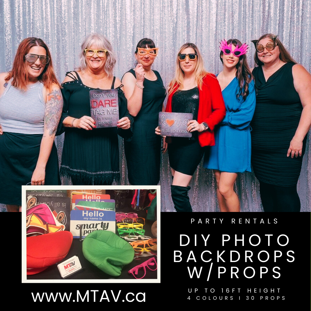 Group of people posing with props in front of a backdrop, advertising party photo rentals.