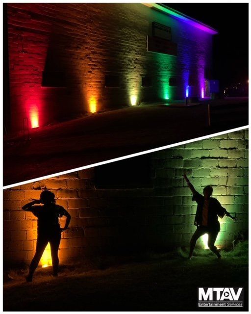 Two panels: building lit with red to purple lights. Silhouetted people pose in front of lit wall, yellow and green lights.