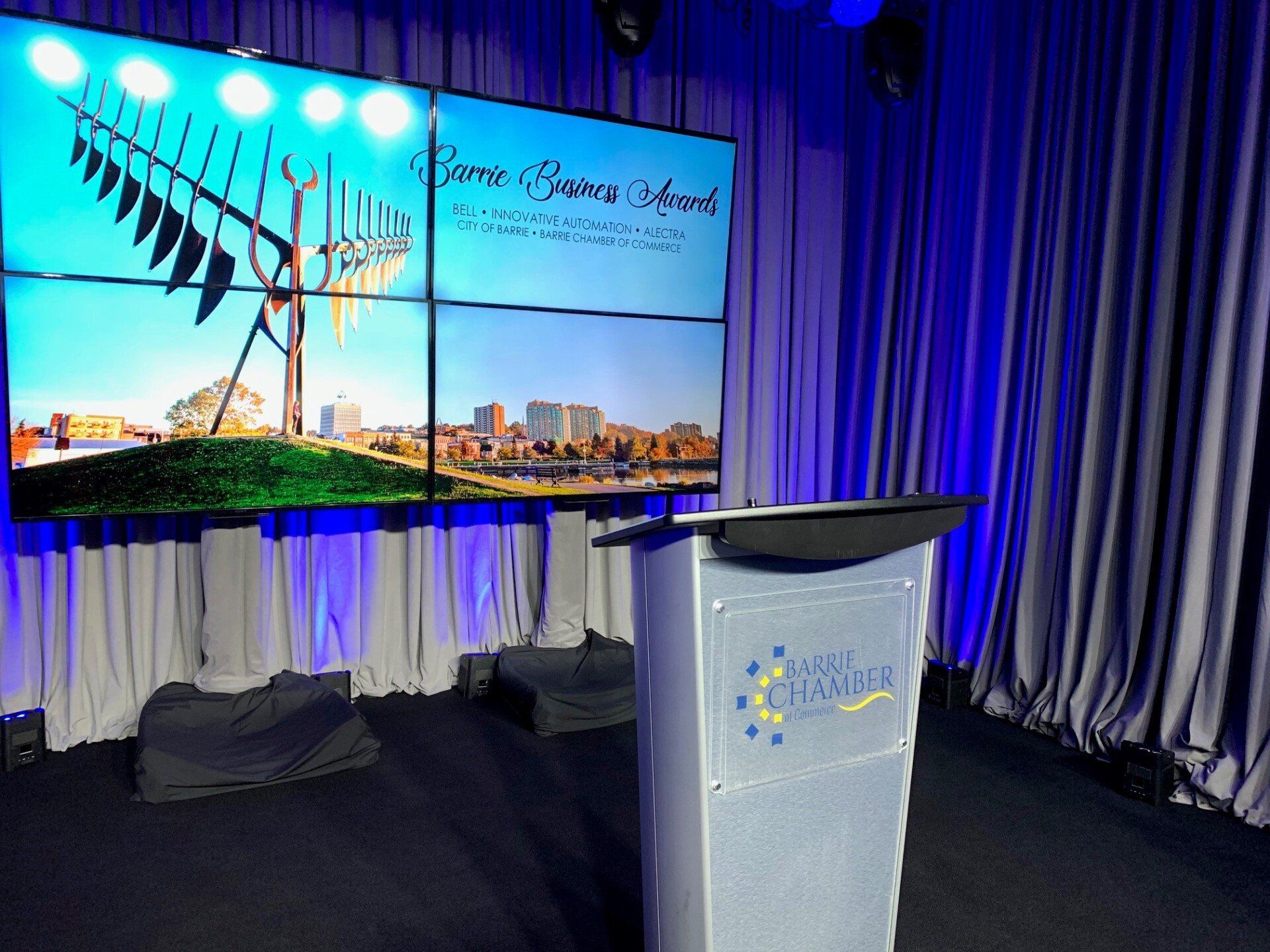 Presentation stage with large screen displaying 