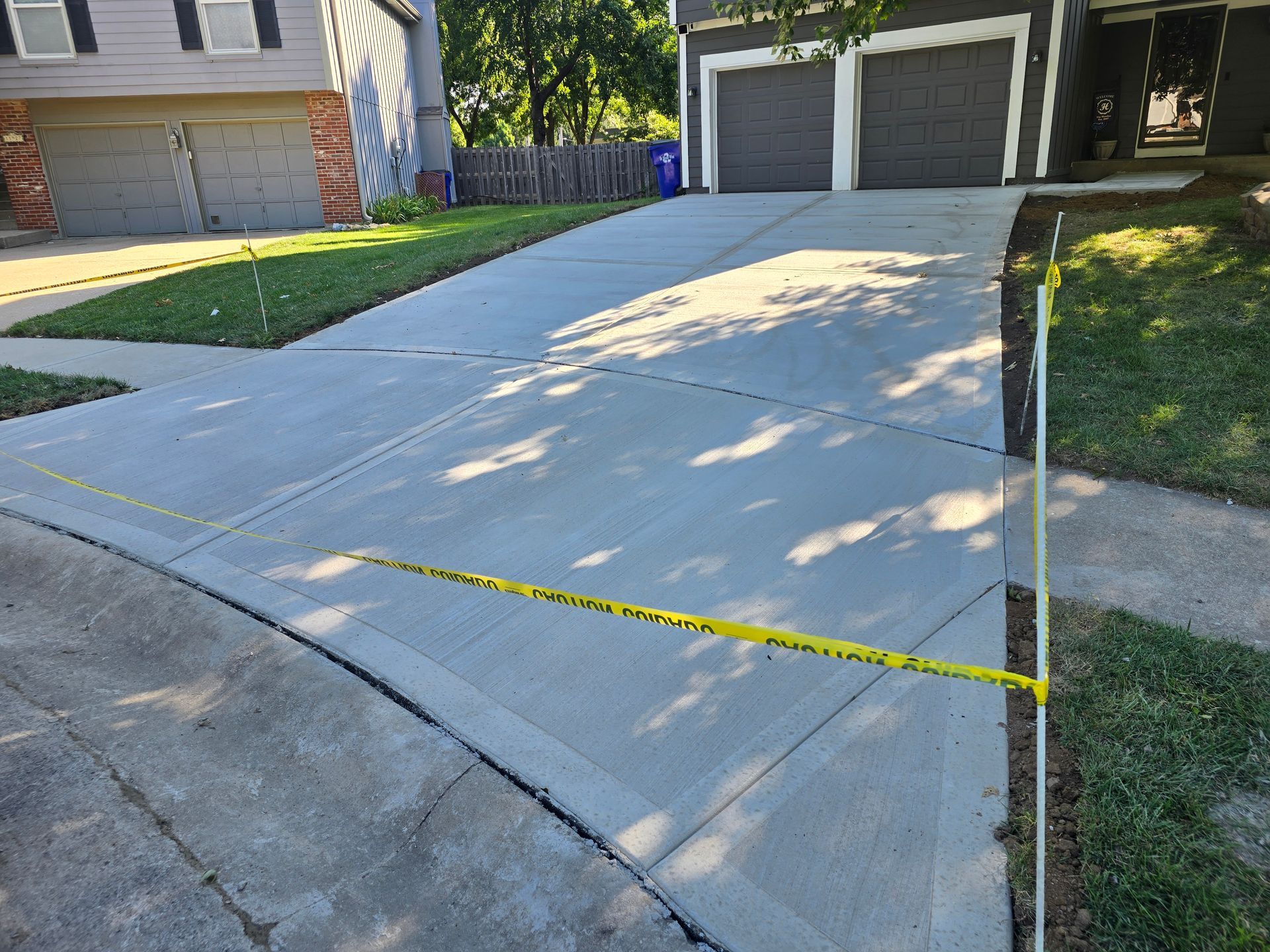 Concrete driveway marked with yellow caution 