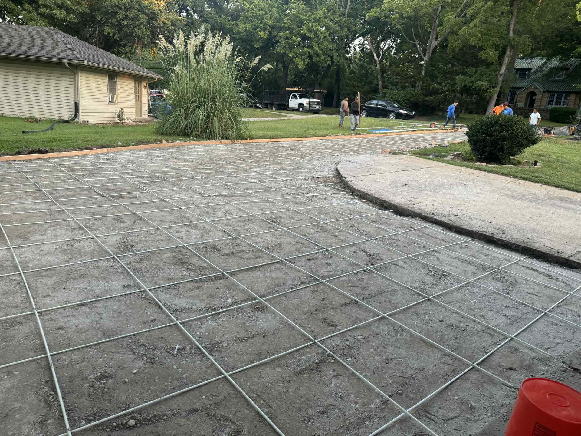 Wide paved driveway with a curved curb