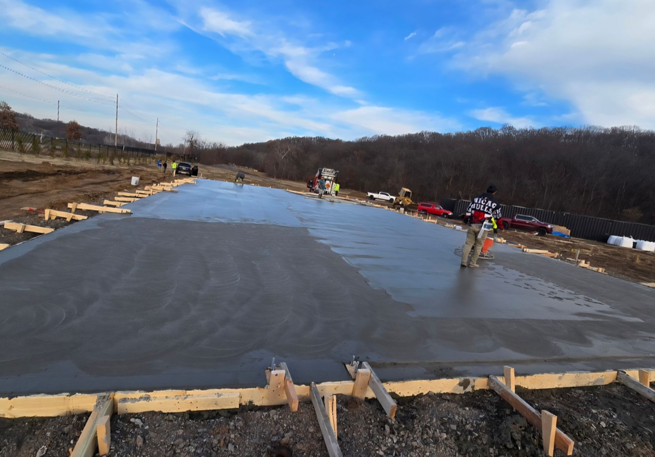 Concrete foundation slab being poured at a construction site