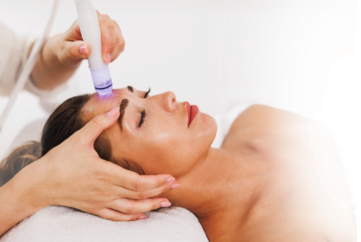 A woman is getting a facial treatment at a spa.
