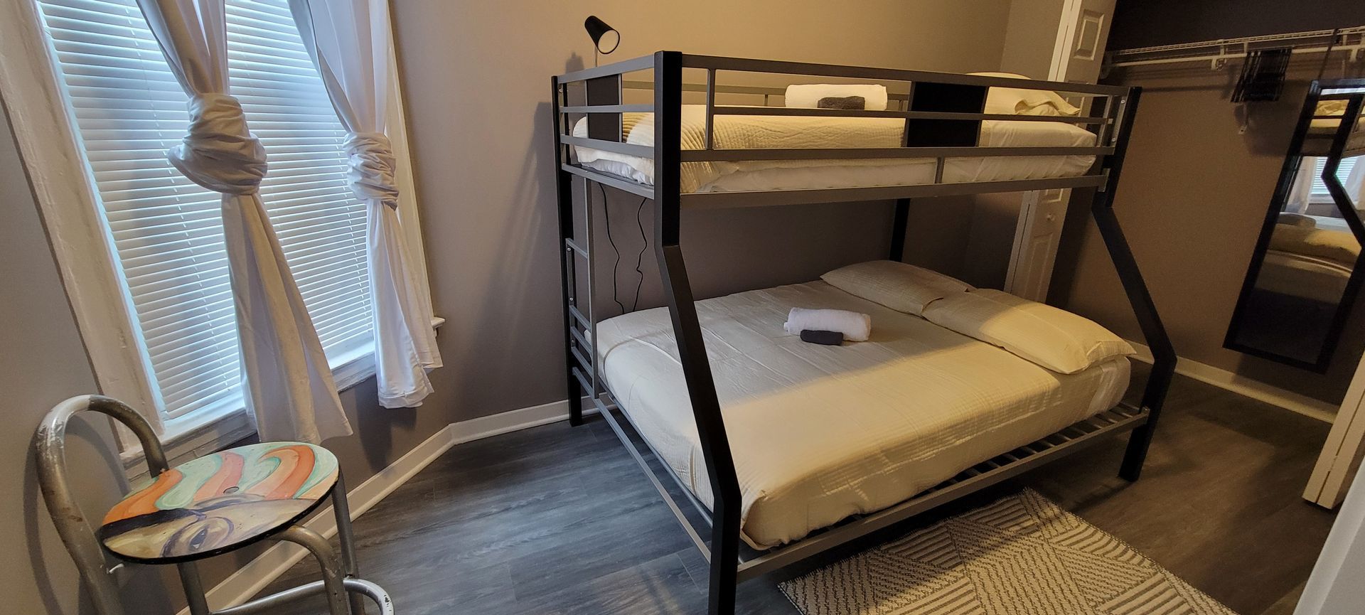 A bedroom with a bunk bed and a table.