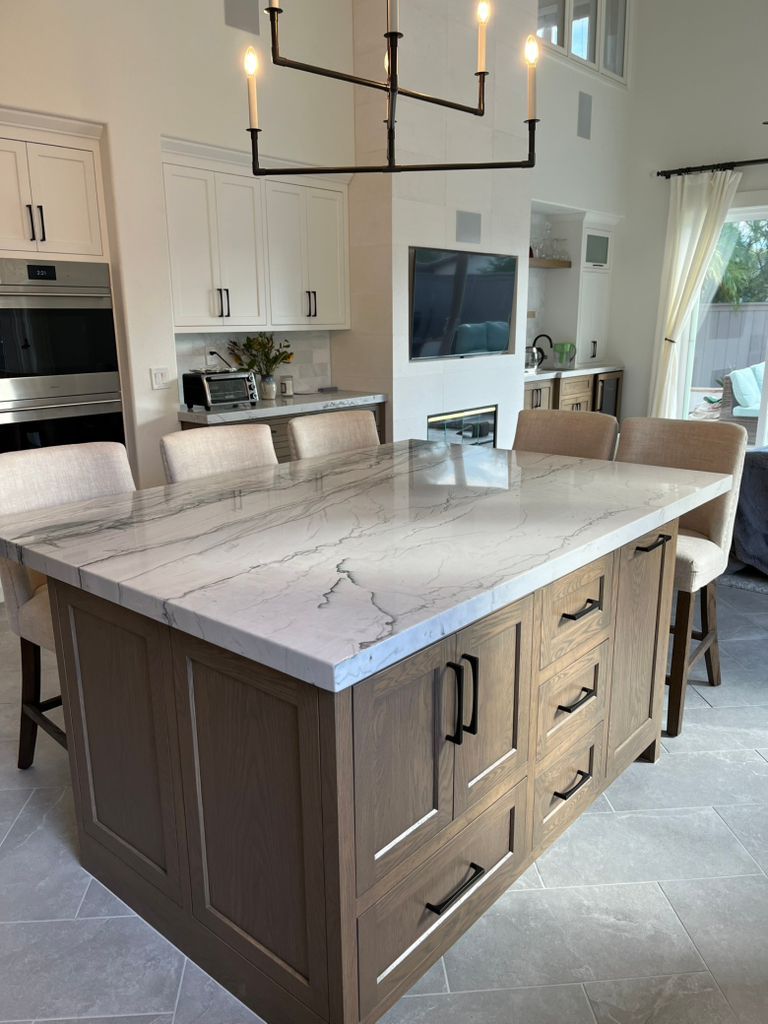 There is a large island in the middle of the kitchen.