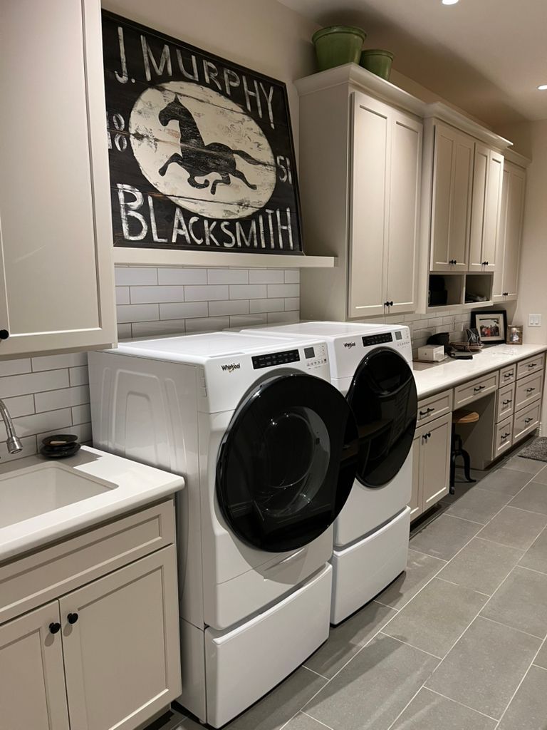 A laundry room with a sign on the wall that says j. murphy blacksmith.