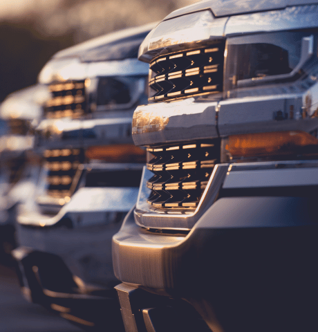 Row of heavy-duty pickup trucks parked together.