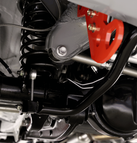 Close-up of performance suspension components including a coil spring and control arms.