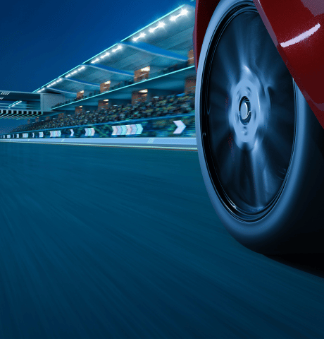 Close-up of a performance vehicle wheel in motion on a racetrack.