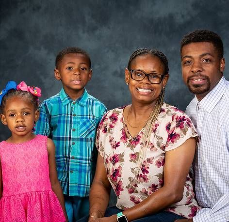 A family is posing for a picture together.