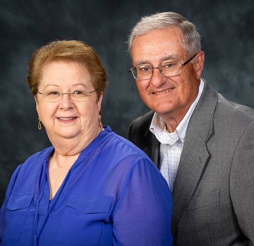 A man and a woman are posing for a picture