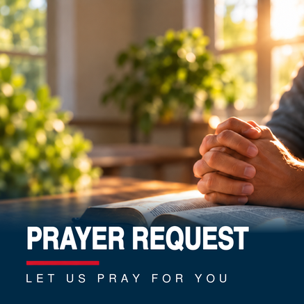 A person is praying with their hands folded over a bible