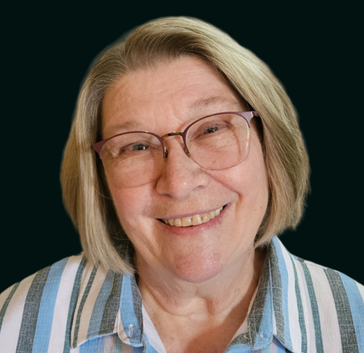 A woman wearing glasses is smiling.