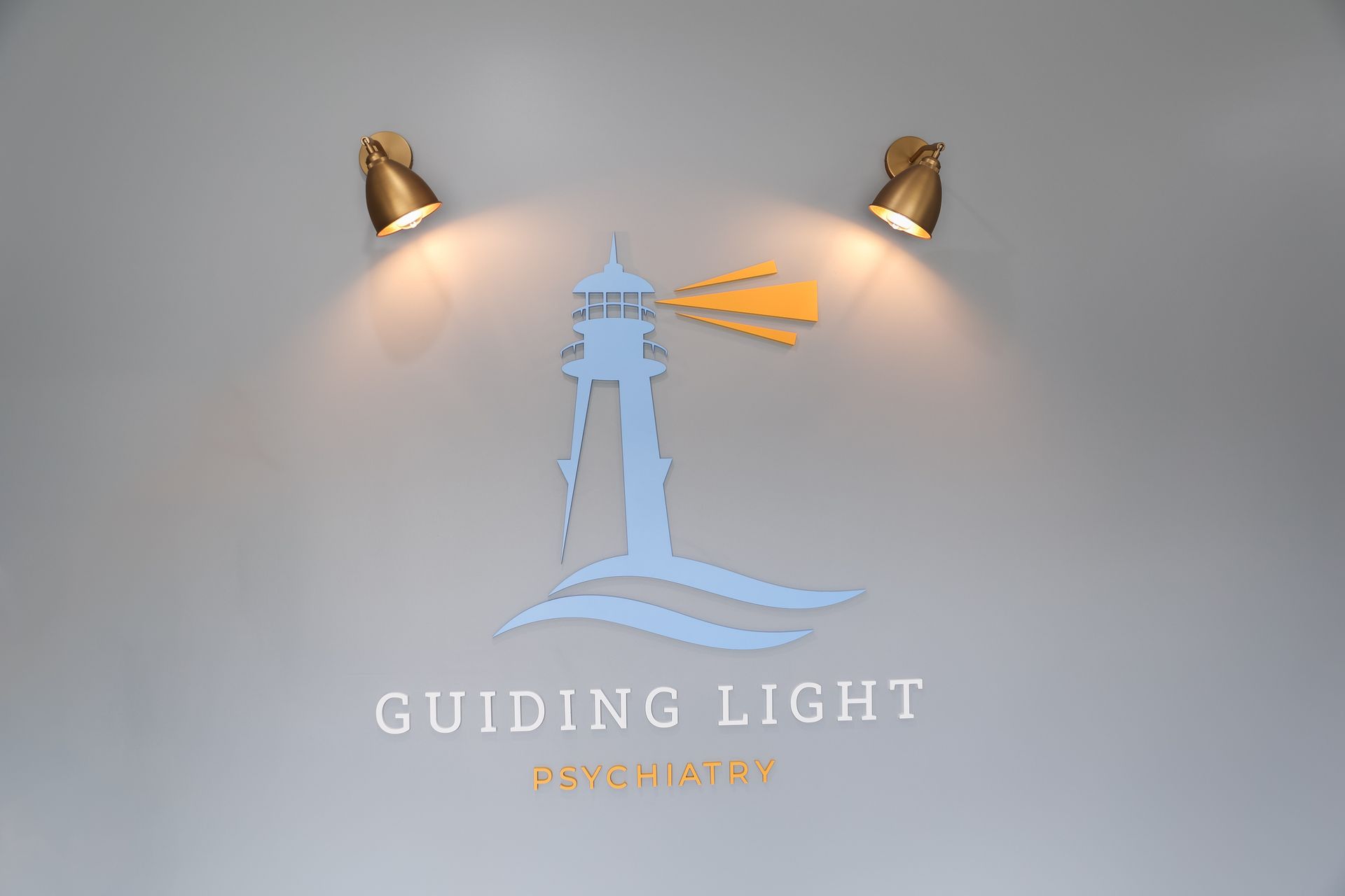 Logo: Light blue lighthouse with orange beams; 