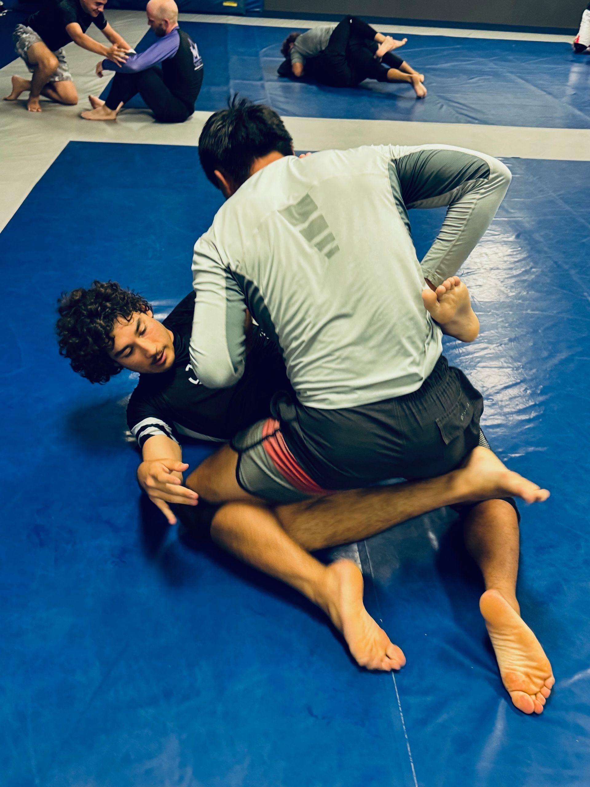 Students drilling brazilian jiu jitsu at Paragon Simi Valley in Simi Valley, CA to build calm focus under pressure.