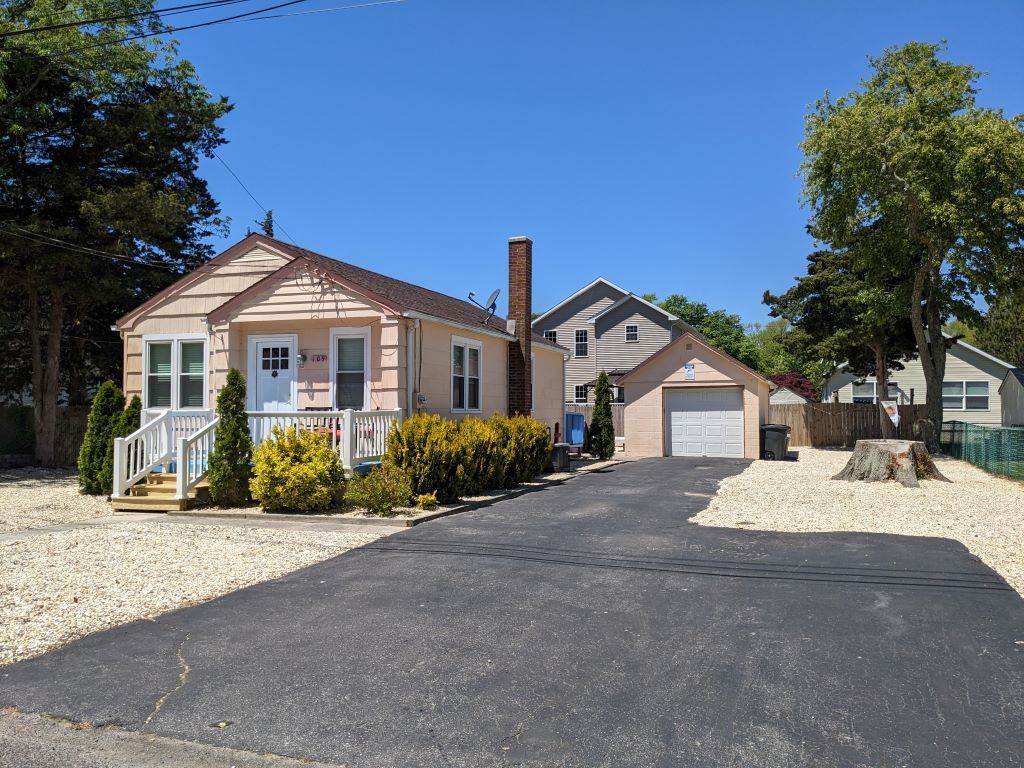 A house with a garage and a driveway in front of it