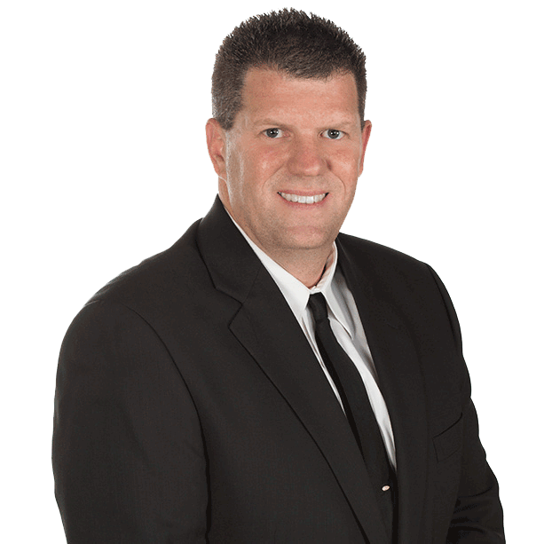 A man in a suit and tie is smiling for the camera.
