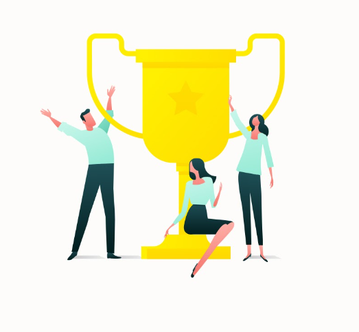 a group of people are standing around a trophy .