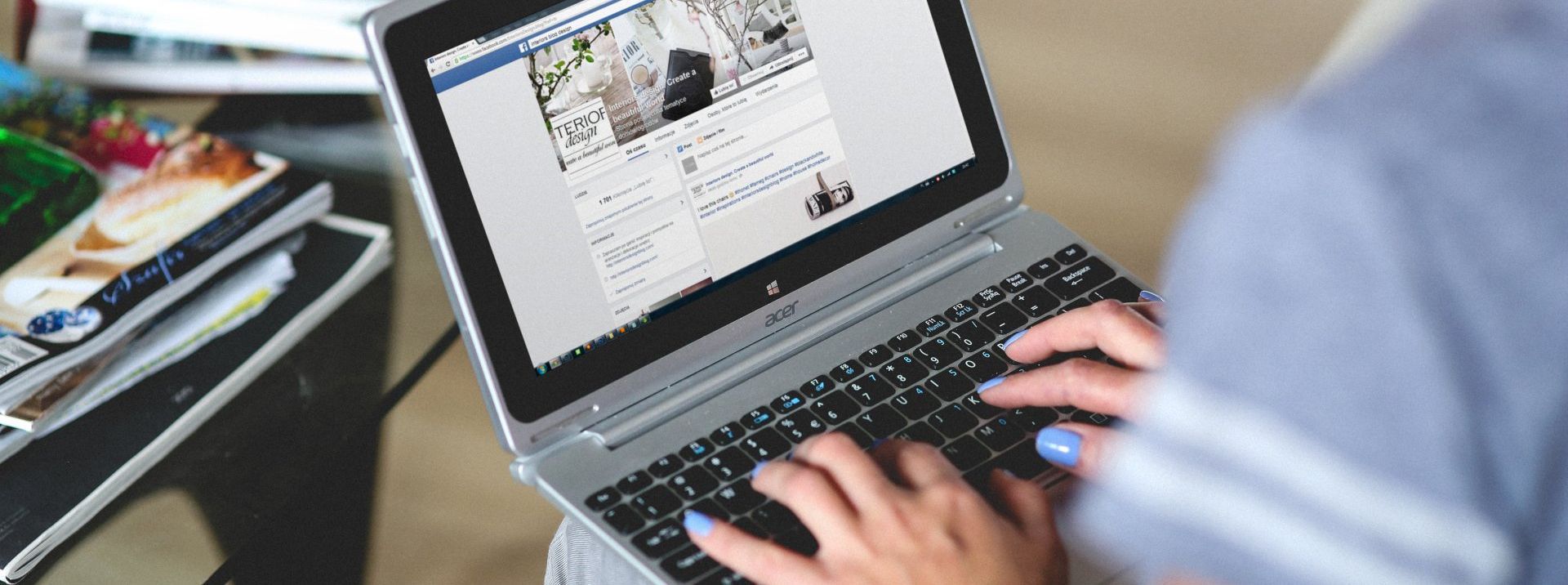 a woman is typing on a laptop computer 