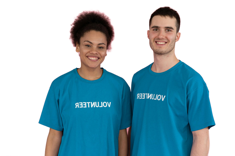 Two volunteers in blue shirts smiling against a white background
