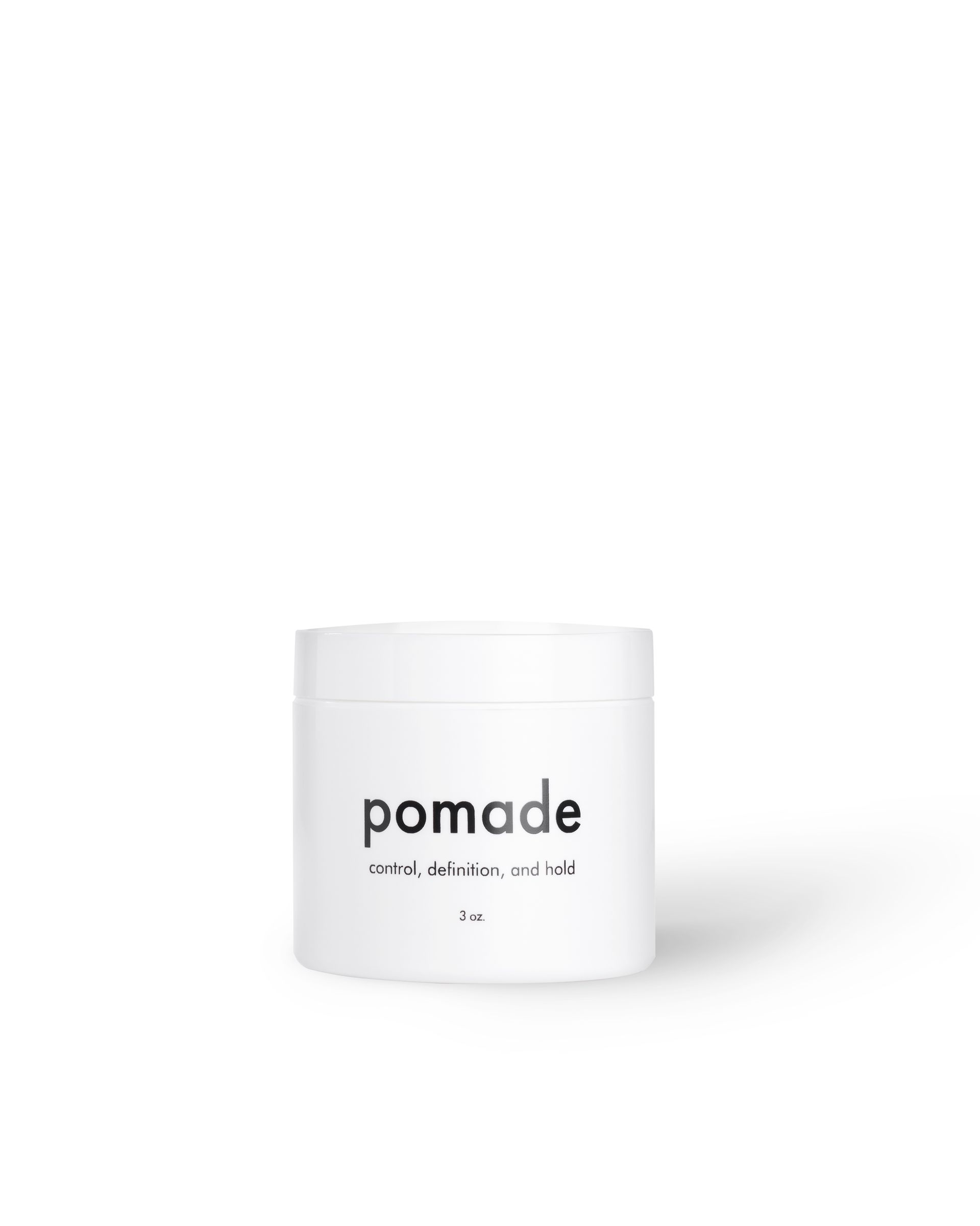White circular jar with black text reading pomade and control definition hold tagline