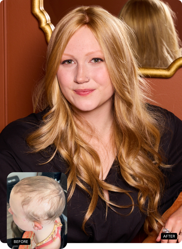 Woman with long blonde hair in a black outfit, posing indoors against a warm-toned wall and mirror.