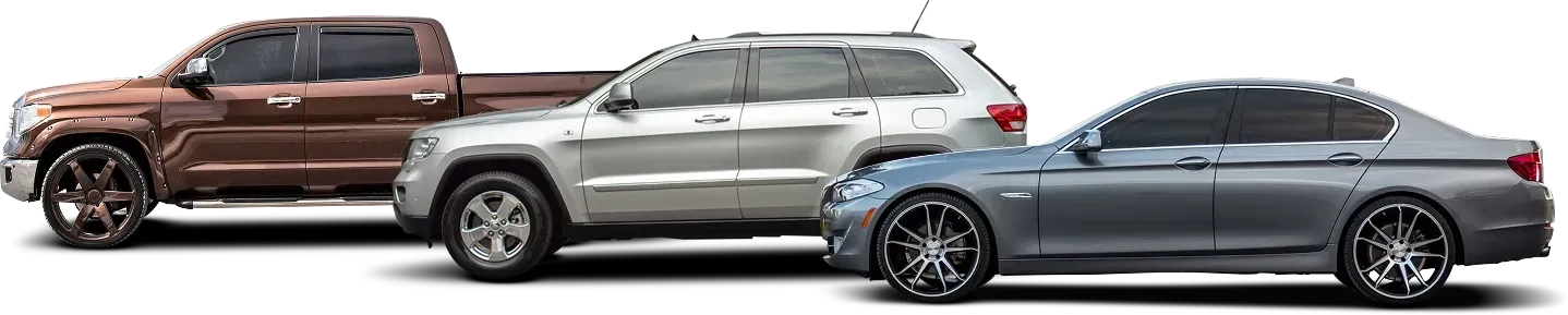 Brown truck, silver SUV, blue car parked, side view | Monroe Goodyear