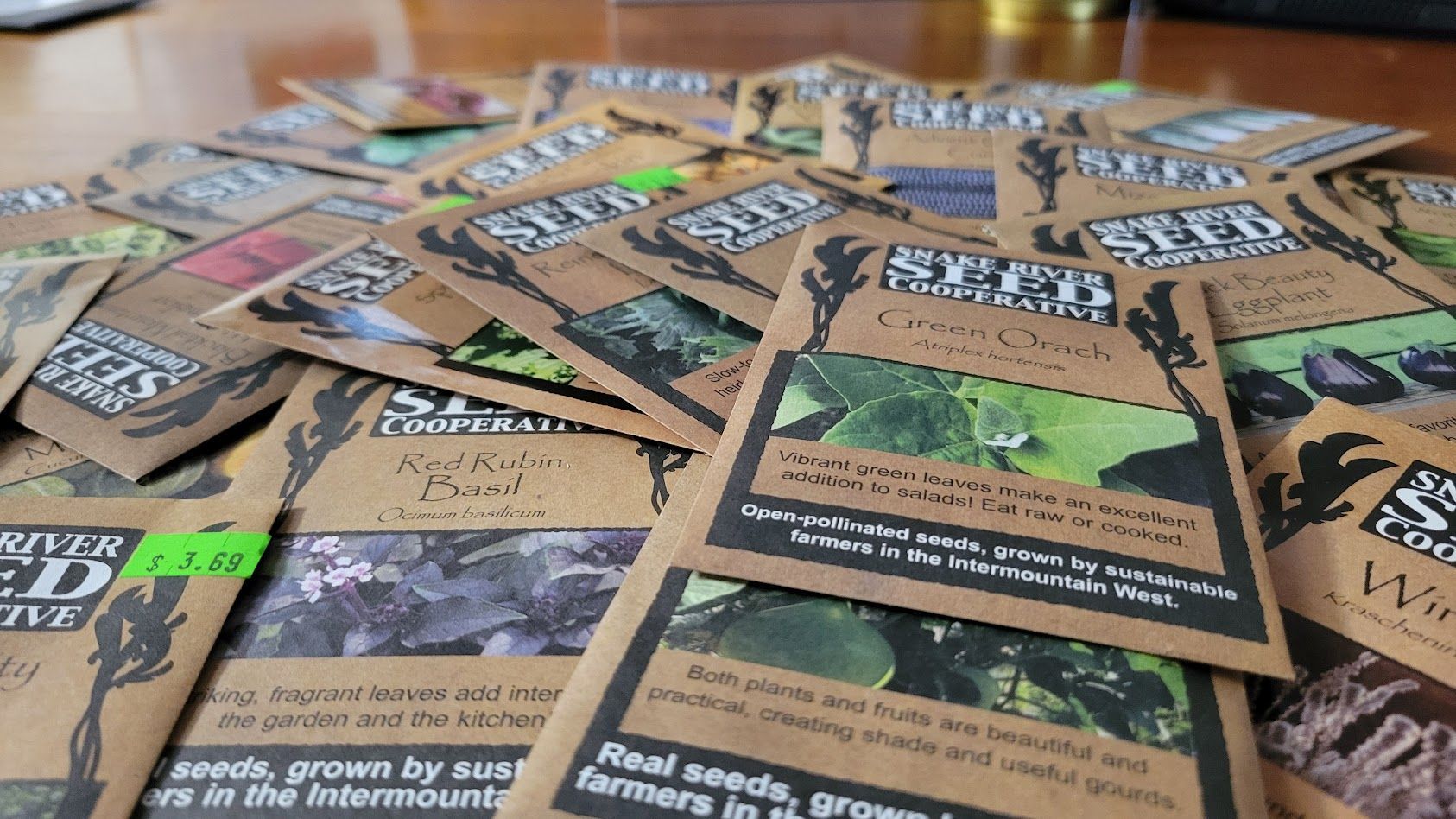 A pile of seed packets donated to the Lunenburg Seed Library by Snake River Seed Cooperative