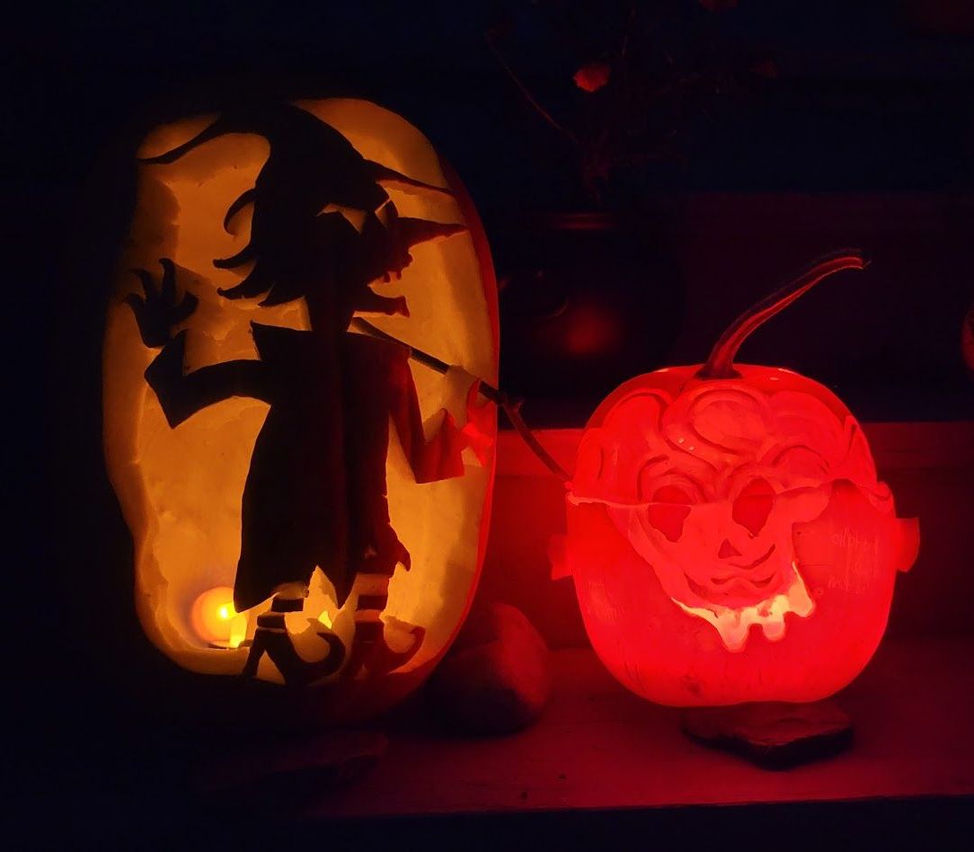 Carved pumpkins adorn the porch at Ostara's Grove pumpkin patch in Vermont