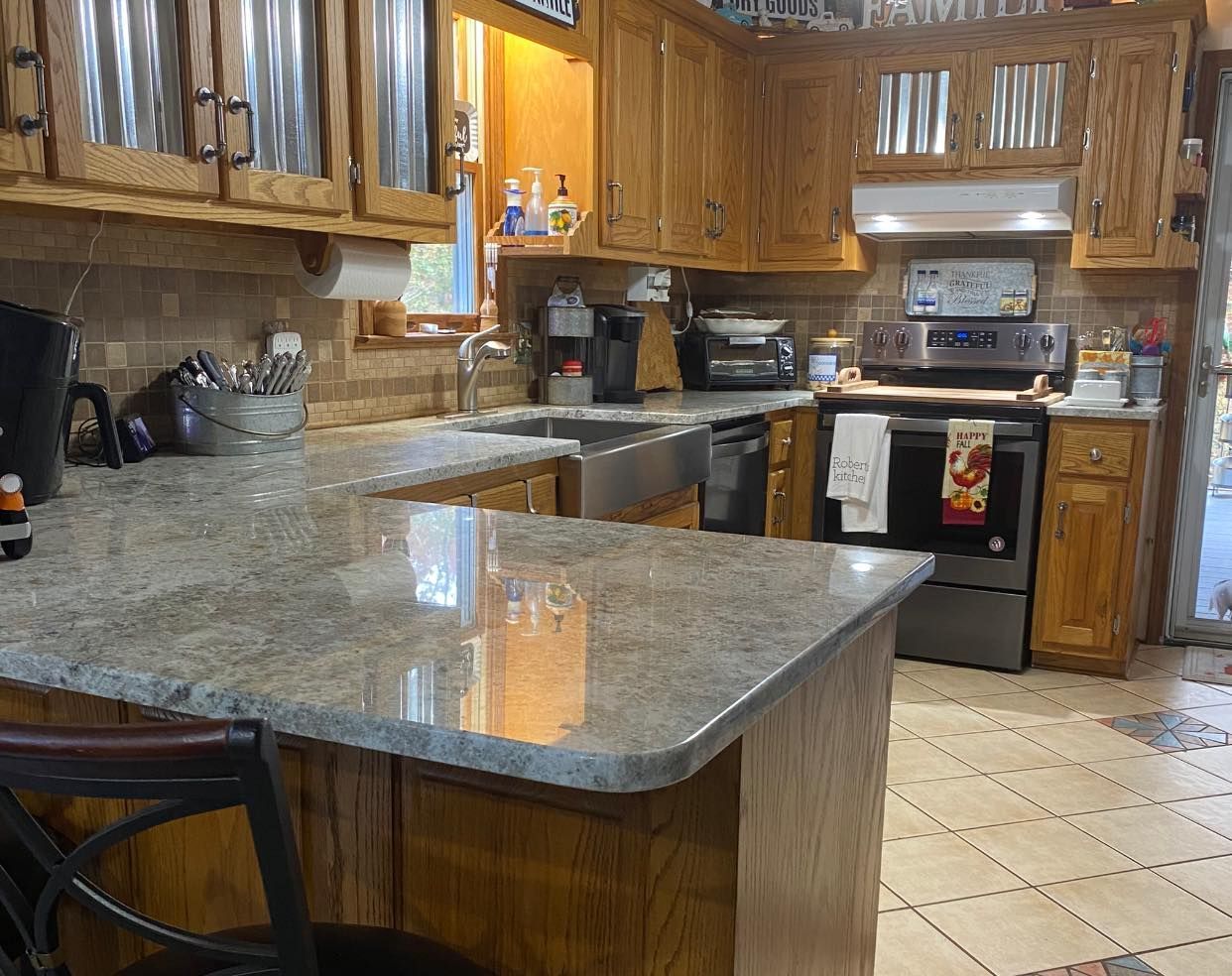 A kitchen with granite counter tops and wooden cabinets
