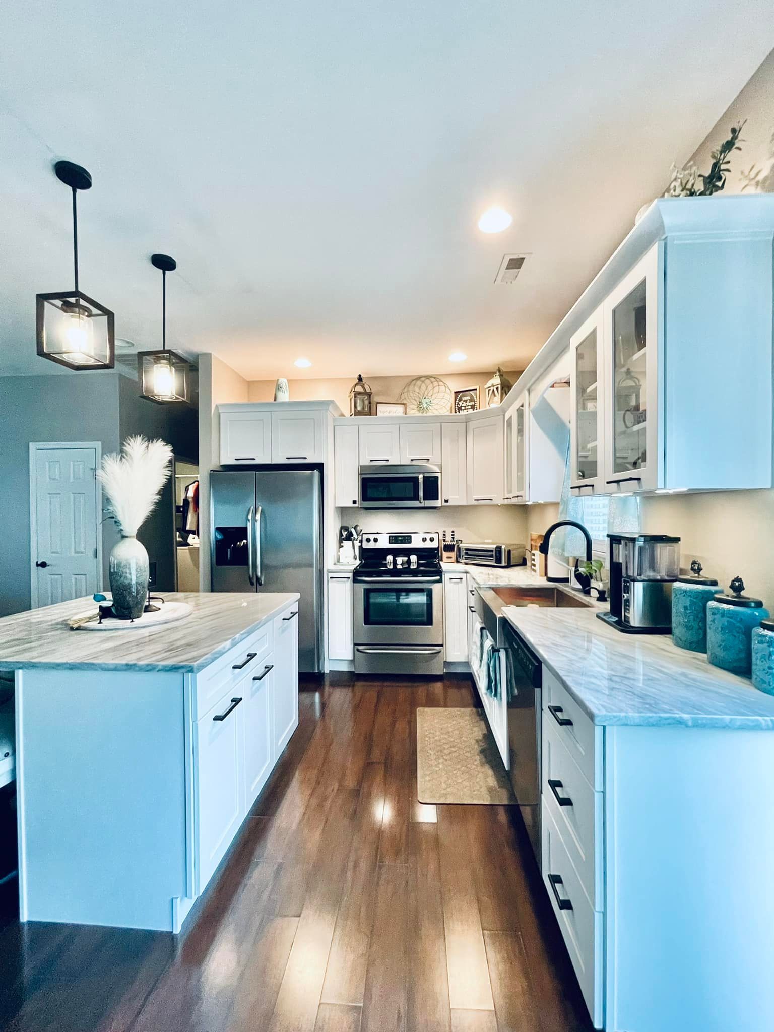 A kitchen with white cabinets and stainless steel appliances