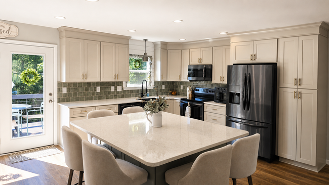 Bright modern kitchen with white cabinets, island seating, and stainless steel appliances