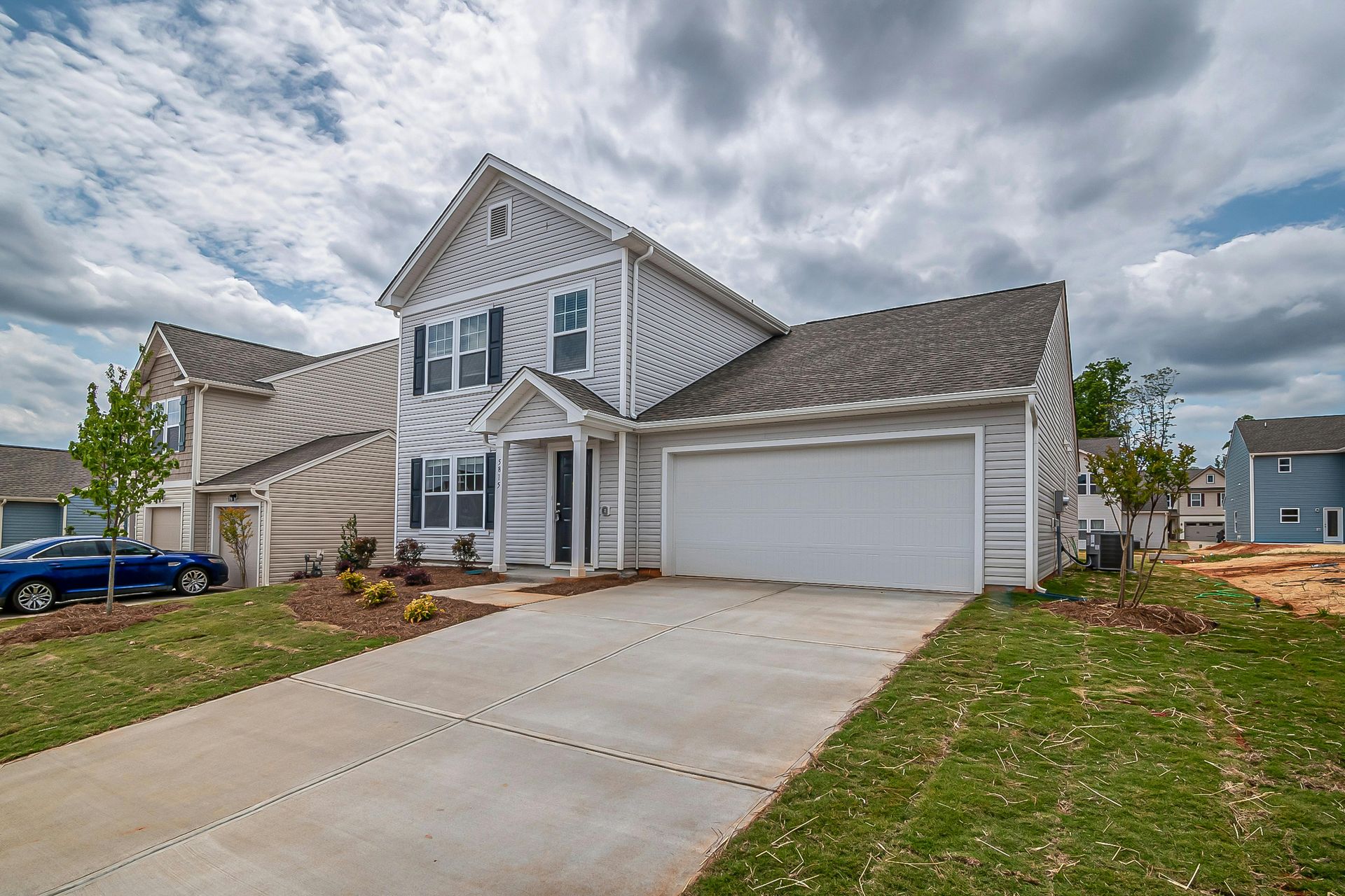 Modern home with a smooth concrete driveway installed by expert concrete driveway contractors