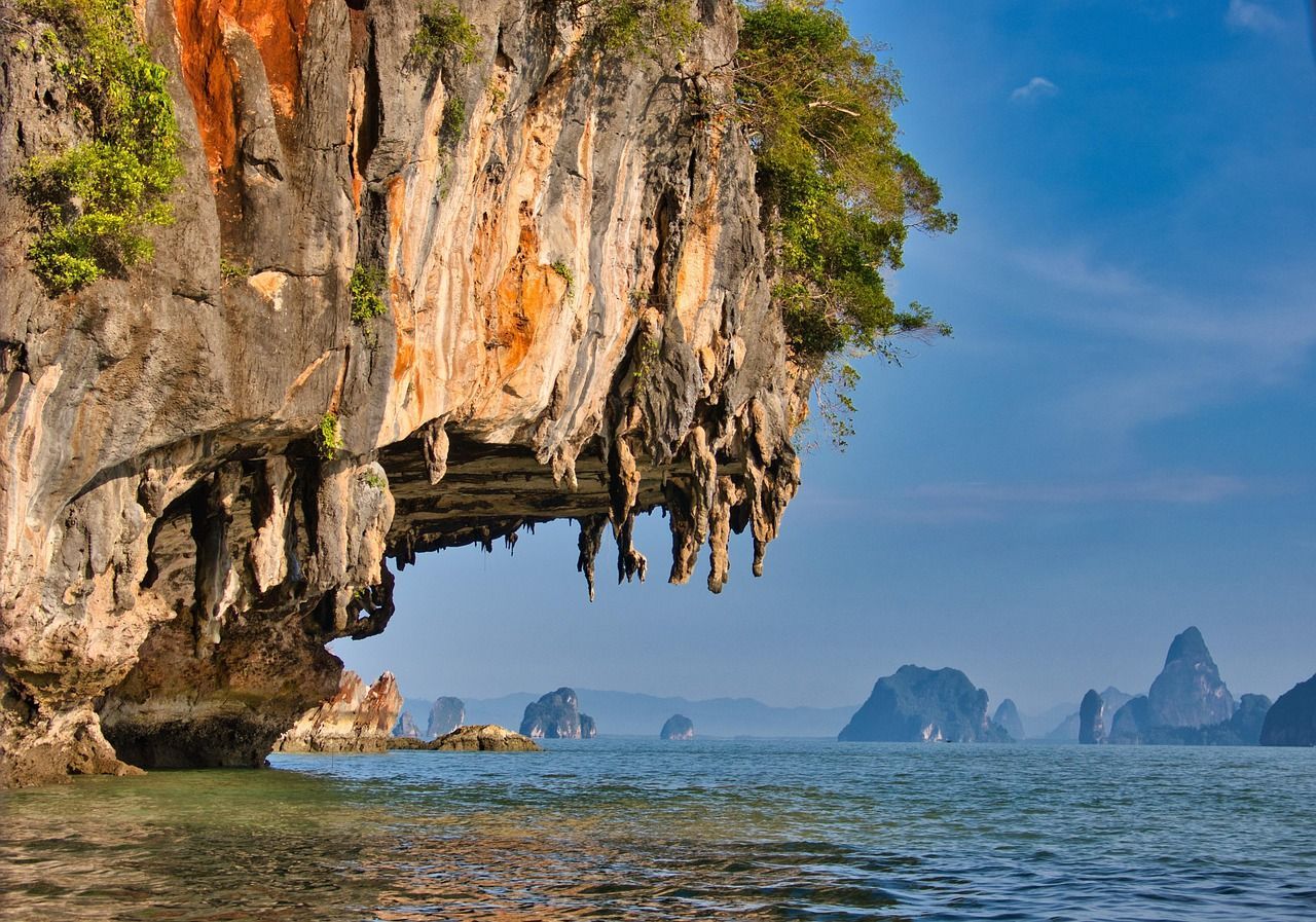 A large rock formation in the middle of a body of water.