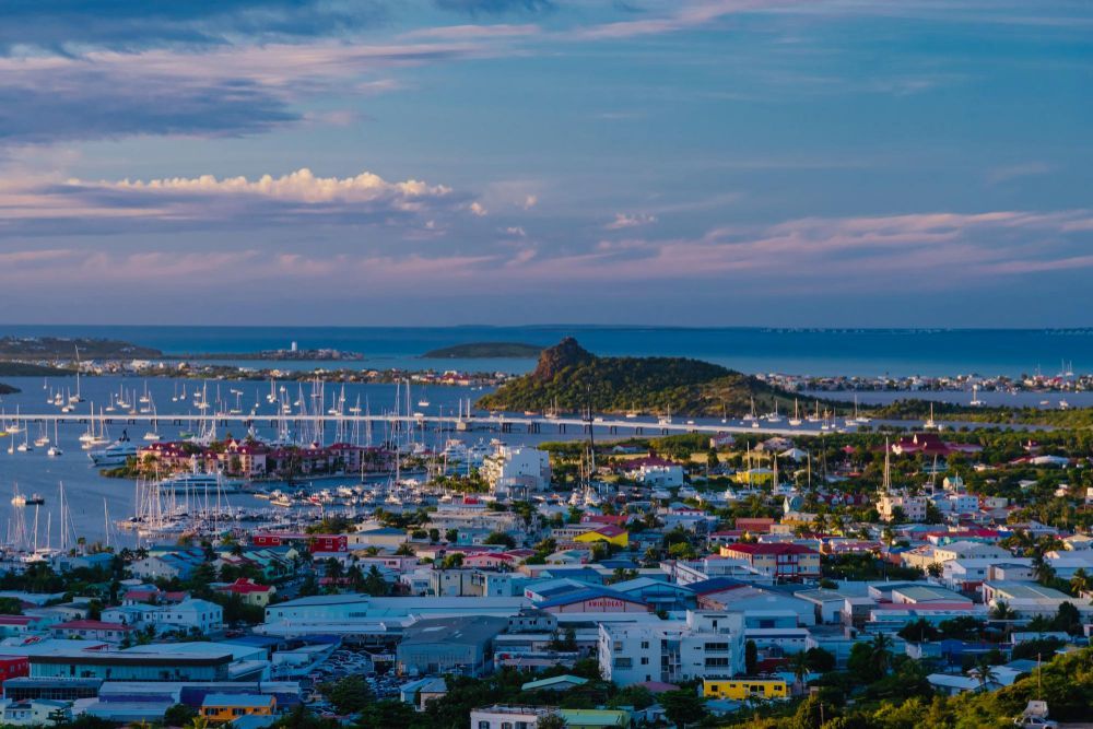 An aerial view of a city with boats docked in the water in Bridgetown.