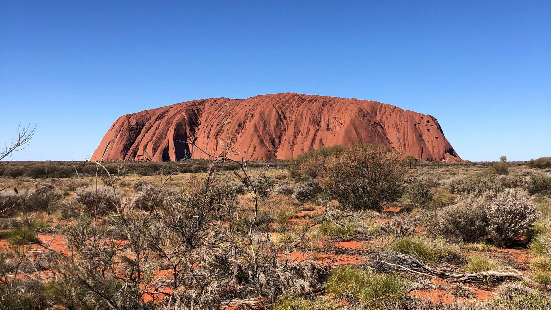 A large rock formation in the middle of a desert.
