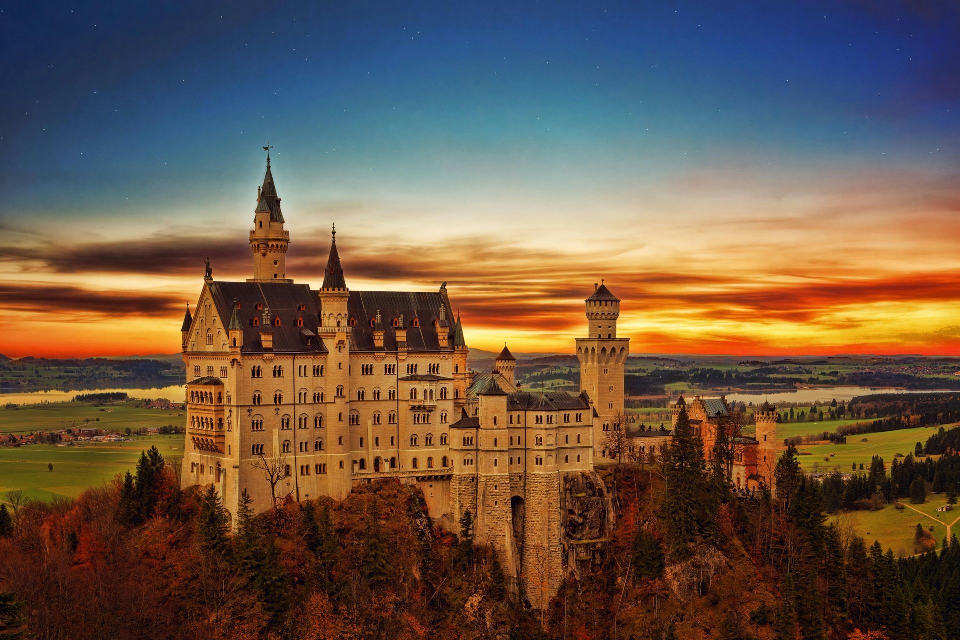 A large castle is sitting on top of a hill at sunset in Rhine Valley