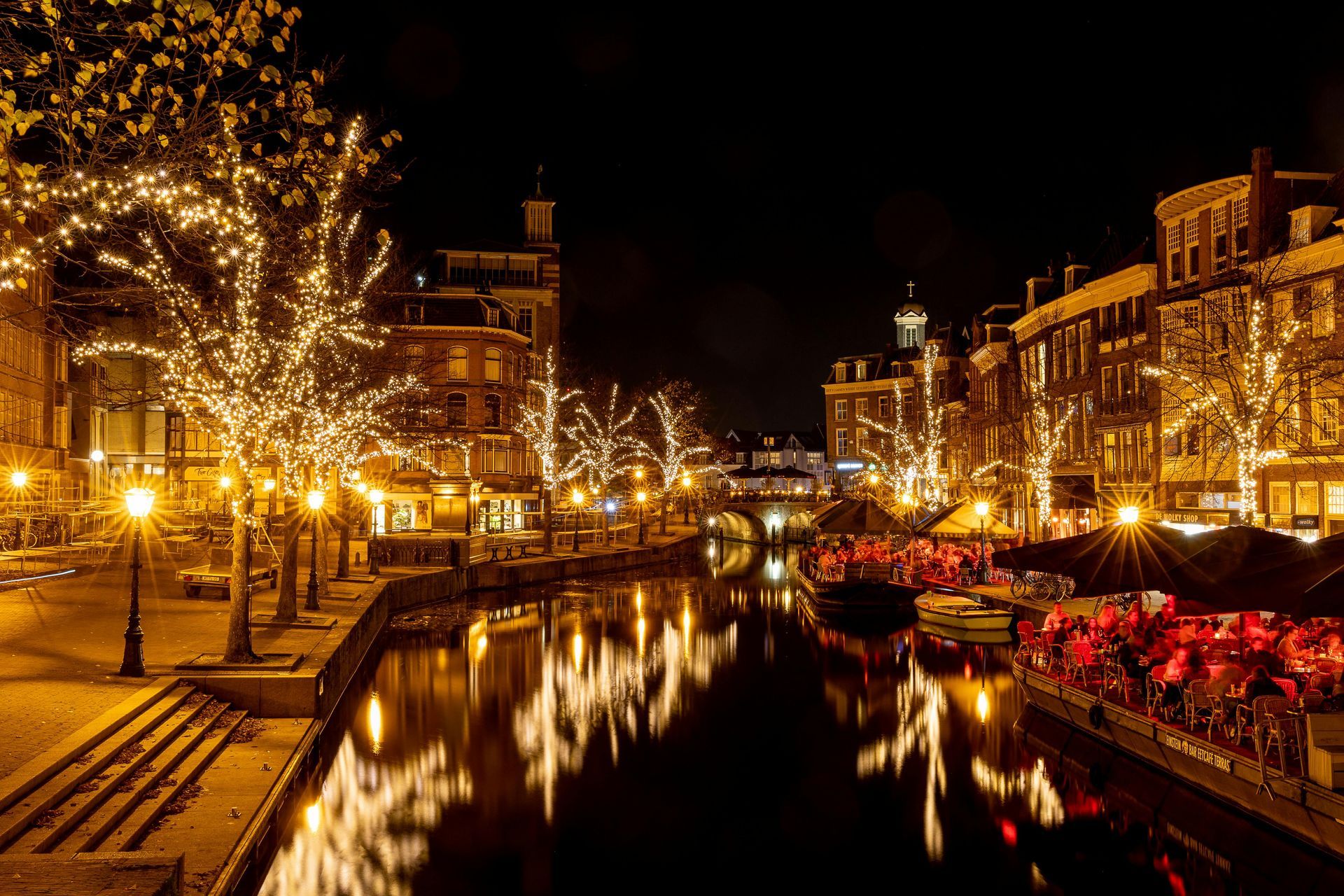 A city at night with a river and buildings lit up