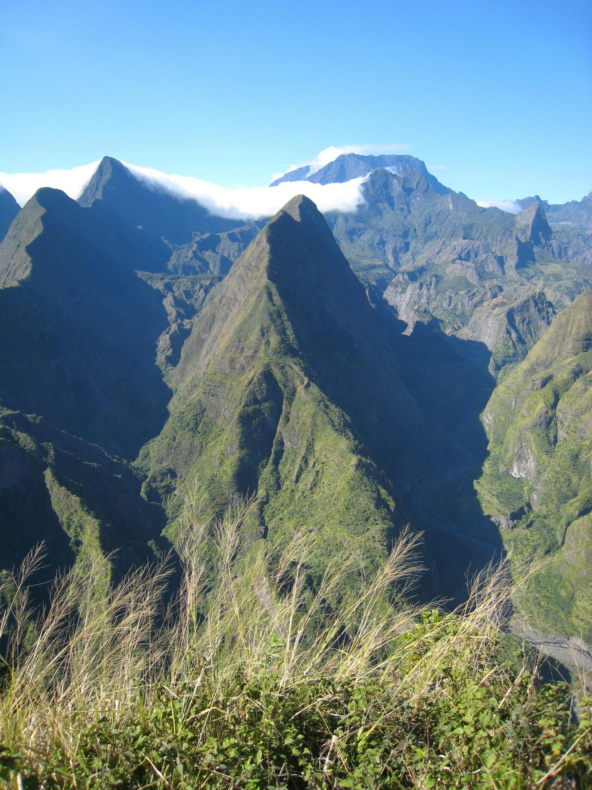 A view of a mountain range with a blue sky in the background of Reunion island