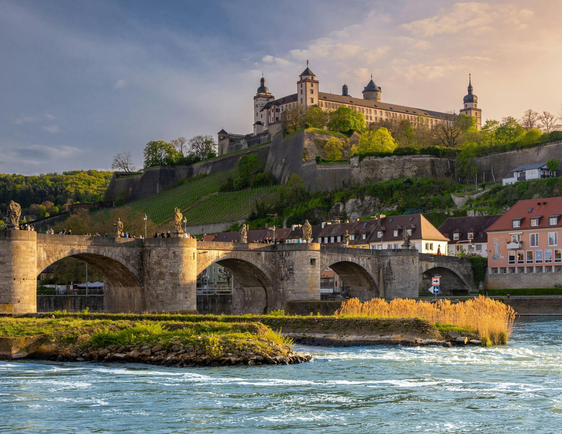 A bridge over a river with a castle in the background in Rhine Valley