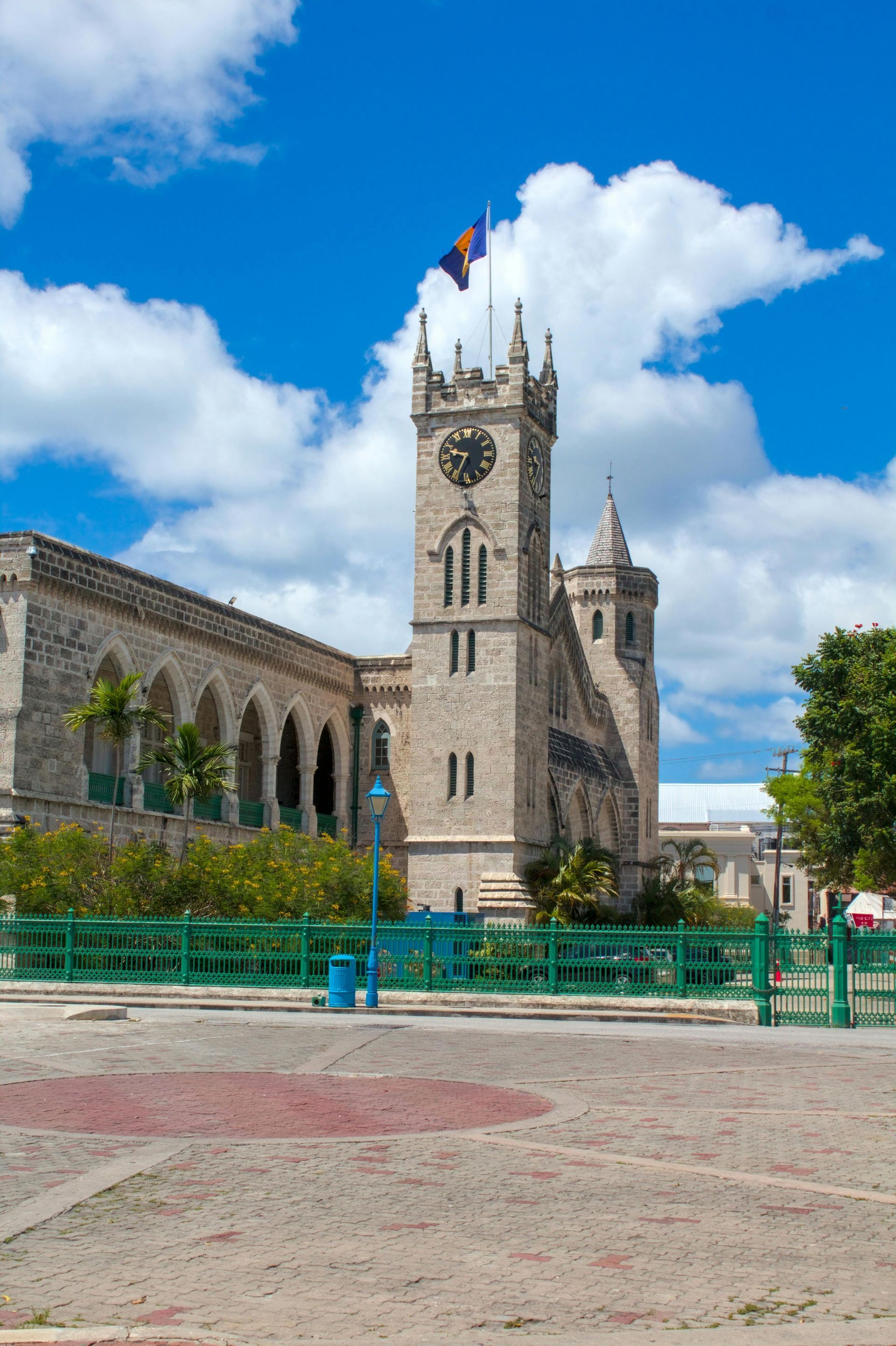 Parliament Buildings in Bridgetown, Barbados, with a clock tower flying the nati.