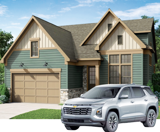 A two-story green house with tan trim and a garage, featuring a silver Chevrolet Traverse SUV parked in front.