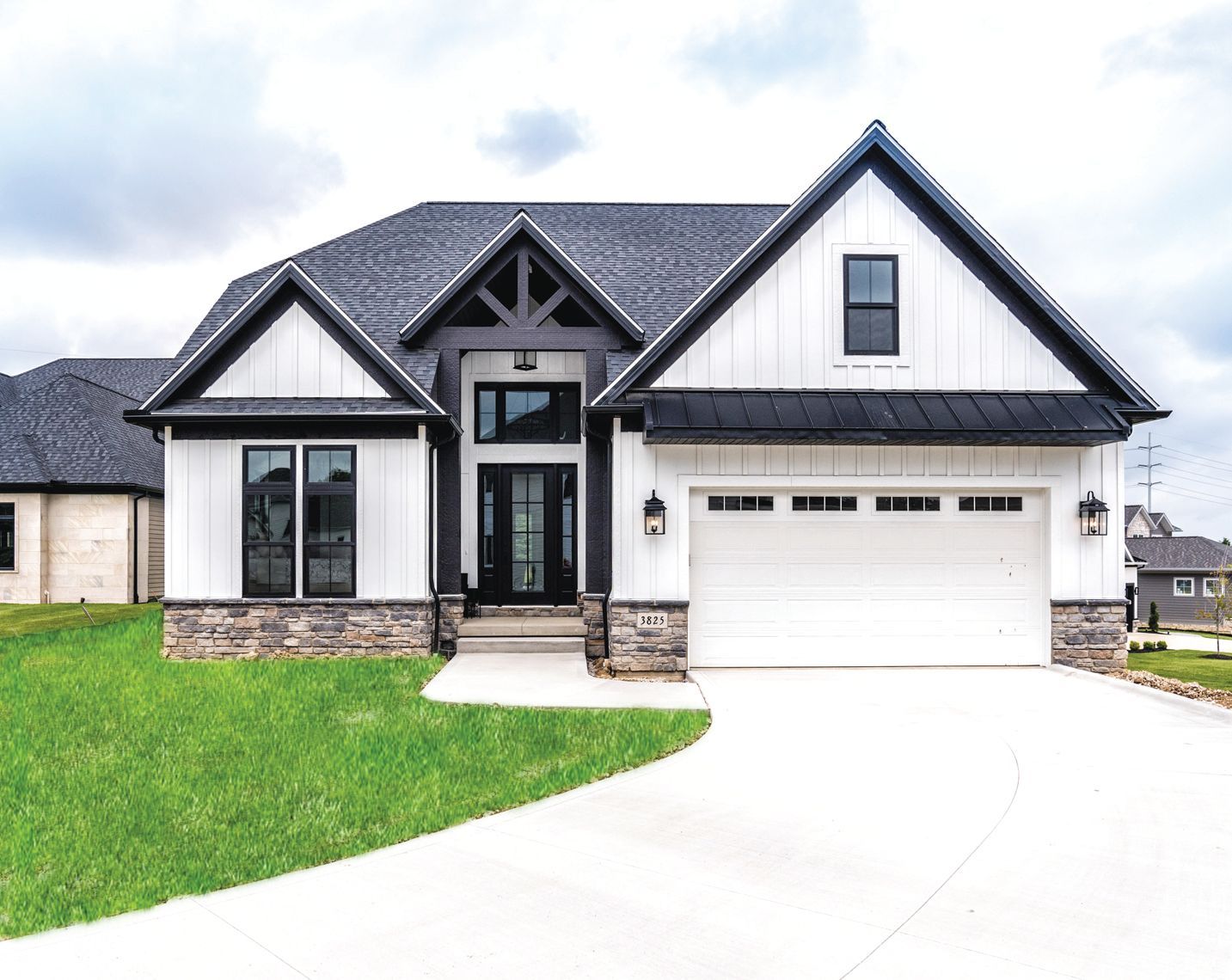 A modern one-story home with white board-and-batten siding, black trim, a stone base, and a two-car garage.
