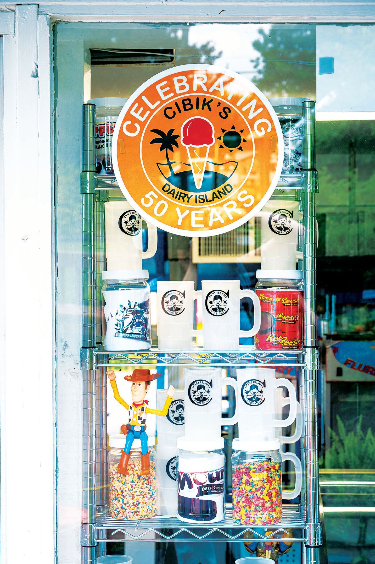 A shop window display features a 