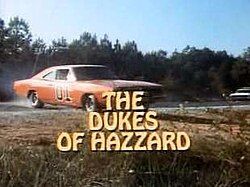 The orange General Lee car from The Dukes of Hazzard drifts on a dirt road, overlaid with the show's title.