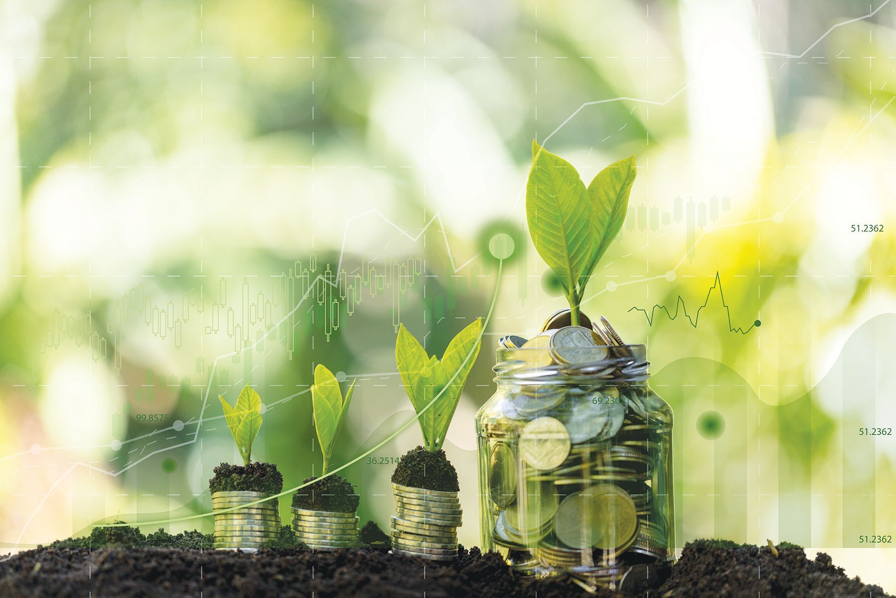 Coins stacked in the soil with small green plants growing from them next to a glass jar filled with coins.