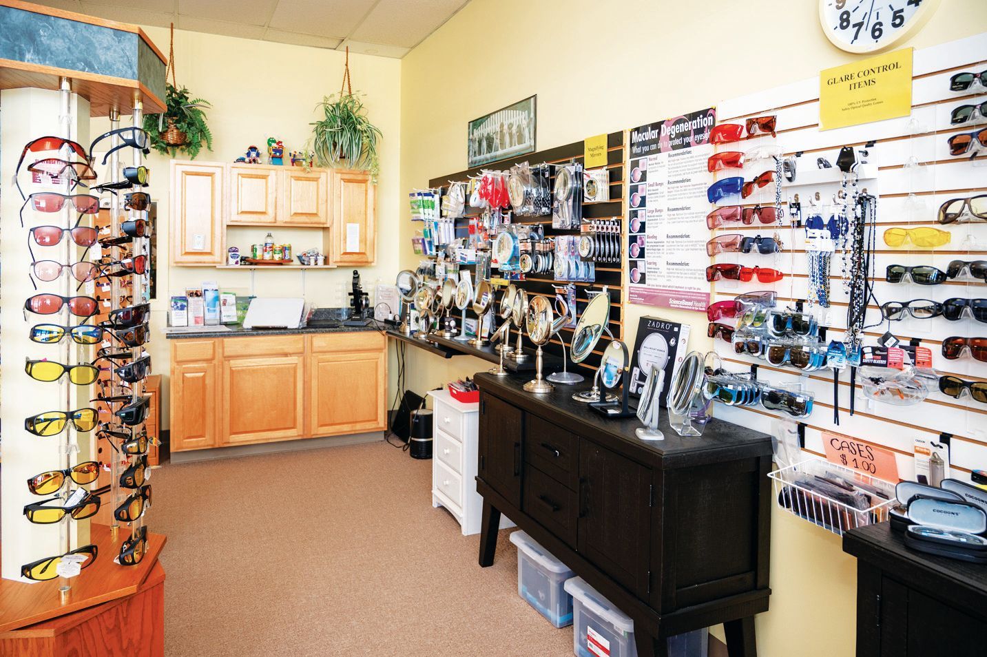 Interior of an eyewear shop featuring rows of sunglasses on circular rotating stands and wall-mounted display racks.