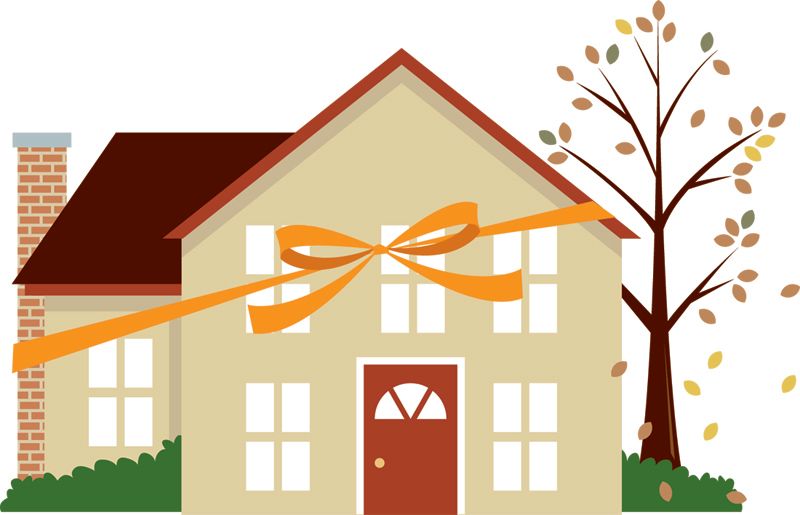 A tan house with a red door and brick chimney, wrapped in an orange ribbon, standing next to a tree with falling leaves.